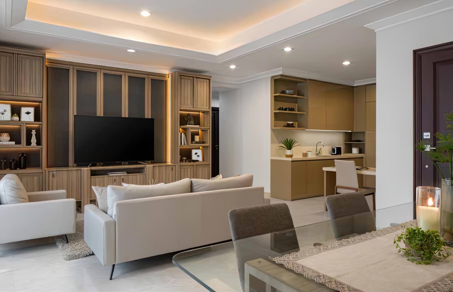 Sala de estar sofisticada com móveis planejados, incluindo painel de TV e estante iluminada.