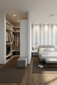 Banheiro aberto para o quarto com banheira de imersão, bancada de quartzo com duas cubas e revestimento em tons neutros.