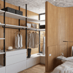 Closet aberto planejado em madeira escura com nichos iluminados por fitas de LED verticais e roupas organizadas por cores. Exemplo de vantagens closet aberto.